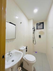 a white bathroom with a toilet and a sink at Vista Bangi Muji-styled 3BR Sunrise view in Kajang