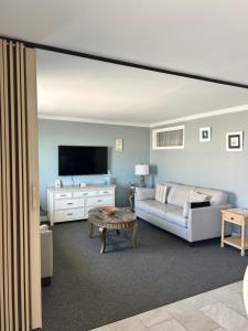 a living room with a couch and a tv at Astronaut Motel in Wildwood Crest