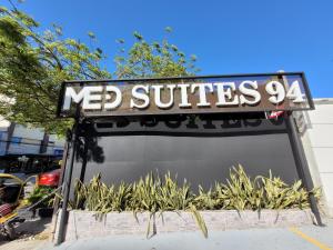 a sign for a n re substitutes store at Hotel Med Suites 94 in Barranquilla +15 photos