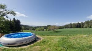 a large inflatable boat sitting in a field at La Maison Rose Bertignat in Bertignat