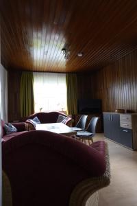 a living room with a couch and a table and chairs at Ferienhaus Hanna in Apen