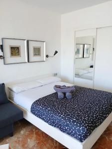 a bedroom with a bed with a bowl on it at studio IN FRONT OF THE SEA in Málaga