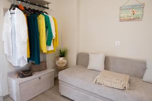 a living room with a couch and some clothes at Diana's Houses in Gythio