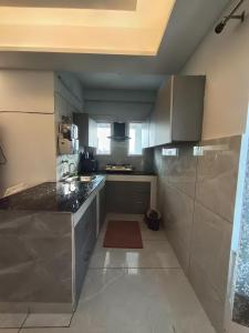 a kitchen with a sink and a counter top at 2BHK Flat Rishikesh Ganga Bhumi- Kaphal Nest in Rishīkesh