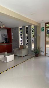 a lobby with a couch in the middle of a room at Rio Hotels Mancora in Máncora +137 photos