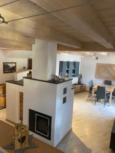 a living room with a fireplace and a table at tabià piz meda in Moena