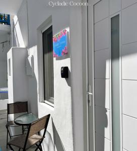 a small balcony with a table and a chair at Cycladic Cocoon Mykonos Town in Megali Ammos +30 photos
