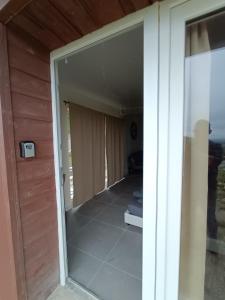 a sliding glass door of a room with a porch at Le Mont Poupet au domaine de Tara in LʼHôpital-du-Grosbois +6 photos