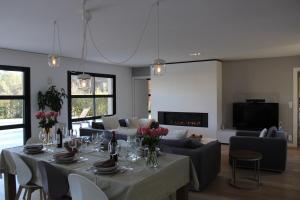 a dining room with a table with flowers on it at Villa Les Jasmins - Le Cannet-Vallauris - Modern with AC, ideal for fun and work in Vallauris