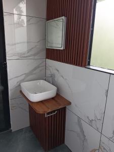 a bathroom with a sink and a mirror at The Tree House in Vythiri