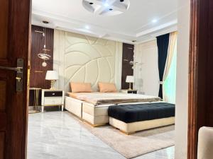 a bedroom with a bed and two tables and two lamps at Bhurban Homes in Murree
