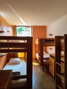 a small room with bunk beds and a desk at Auberge du Pèlerin- Auberge de charme en pierre avec vue sur les montagnes in Saint-Jean-Pied-de-Port