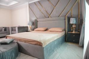 a bedroom with a large bed and a couch at Bhurban Homes in Murree