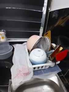 an egg and dishes in a drawer in a refrigerator at Lakefront Homestay in Taiping