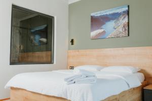 a bedroom with two white beds and a window at Golyaka Stone Garden Hotel in Orhangazi