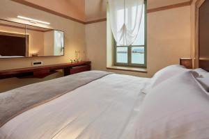 Postel nebo postele na pokoji v ubytování Domus Renier Boutique Hotel