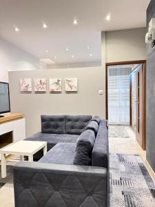 a living room with a couch and a television at Apartament Ząbki in Ząbki +10 photos