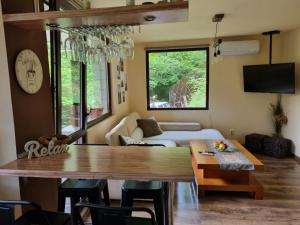a living room with a table and a couch at "Whispering pines" vacation home, close to Sofia in Gola Glava