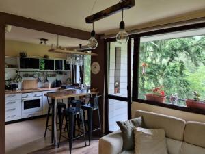 a kitchen with a couch and a table in a room at "Whispering pines" vacation home, close to Sofia in Gola Glava