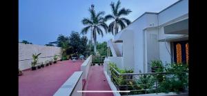 a balcony of a building with palm trees in the background at PENTHOUSE -Thanjavur home stays in Thanjāvūr