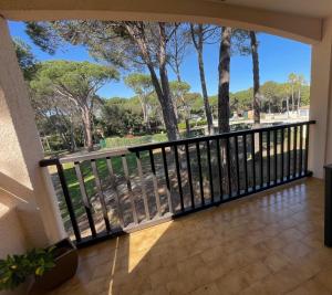 a balcony with a black railing and trees at Appartement Piscine et pinede - Wifi in Saint-Raphaël