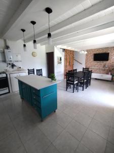 a kitchen and dining room with a table and chairs at La Esperanza in Salta