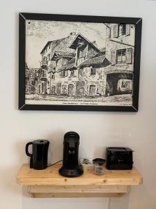 a drawing on a wall above a wooden shelf at Maison de ville - Parking privé in Montbéliard