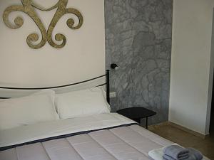 a bedroom with a bed and a wall with a painting at Residence Casa Berti in Spello +54 photos