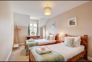 a bedroom with two beds with towels on them at Harbour View - Whitby in Whitby
