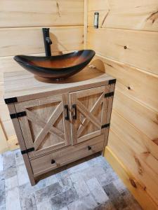 a wooden sink on top of a wooden cabinet in a bathroom at Three bears lodge in Gatlinburg