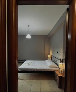 a bedroom with a bed and a ceiling at Elena House in Néa Péramos +12 photos