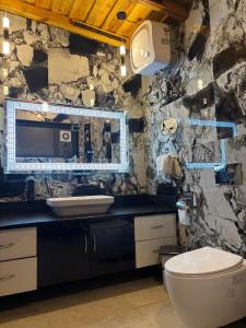 a bathroom with a toilet and a sink at Charlie's Little Palace in Mukteswar +11 photos