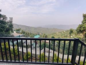 a balcony with a view of a mountain at Charlie's Little Palace in Mukteshwar +11 photos