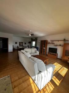 マタラスカニャスにあるMarismas al marの白いソファとテレビ付きの広いリビングルーム