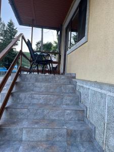 a pair of chairs sitting on the stairs of a house at Casa Dina in Băile Herculane +44 photos