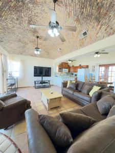 a large living room with couches and a table at El Ojo del Mar - Las Conchas in Puerto Peñasco