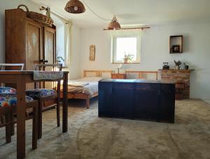 a bedroom with a bed and a table in a room at Na końcu dróżki in Radoniów