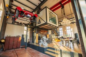 a room with a fire truck hanging from the ceiling at Loft Pumpensaal im historischen Wasserwerk Tecklenburg 150qm Außergewönliches Erlebnis in Tecklenburg +23 photos