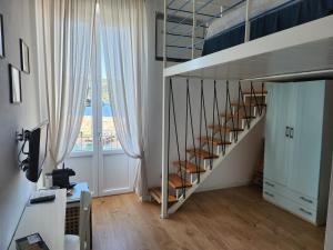a staircase in a room with a large window at Luci del Mari in Ponza