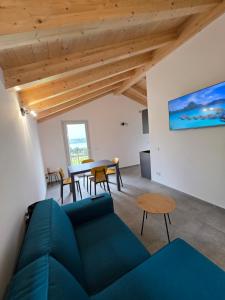 a living room with a blue couch and a table at Al Laghetto apartment - Como Lake in Colico +22 photos