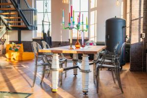 a table and chairs with candles on top of it at Loft Pumpensaal im historischen Wasserwerk Tecklenburg 150qm Außergewönliches Erlebnis in Tecklenburg