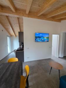 a living room with a table and yellow chairs at Al Laghetto apartment - Como Lake in Colico