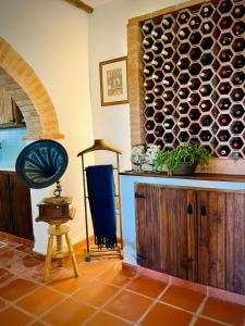 a room with a large wall of wine bottles at The Oak Tree Farm - Open Plan Layout by Portus Alacer in Rabaços +54 photos