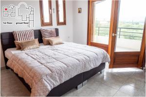 Postel nebo postele na pokoji v ubytování Great Villa Philipi
