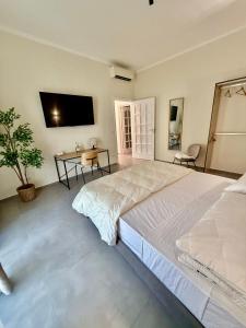 une grande chambre avec un grand lit et un bureau dans l'établissement VK Rooms, à Bari