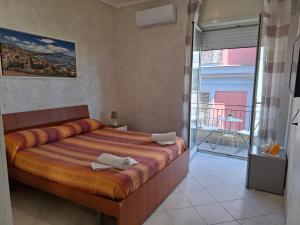 Posteľ alebo postele v izbe v ubytovaní Napoli central