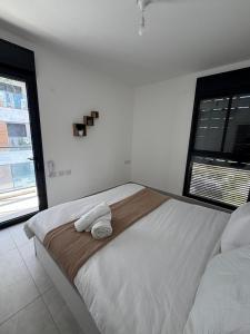a bedroom with a large bed with two towels on it at Boutique Nesher in Nesher