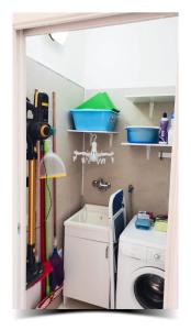 a kitchen with a washing machine and a sink at Donna Lucia Home in Pozzallo