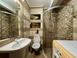 a bathroom with a sink and a toilet and a shower at Къща за гости Роси in Pomorie +35 photos