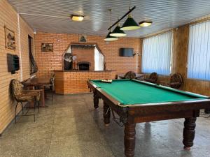a billiard room with a pool table in it at Золотий Берег in Poltava +32 photos